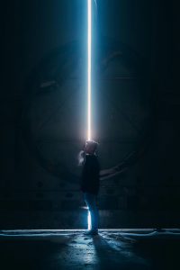 a scene from Science Fiction movie . a man standing in a tunnel with a lasser beam n head